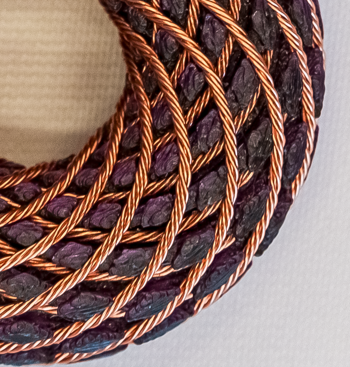 Macro photograph showing the materials and copper winding of an OTORUS pendant
