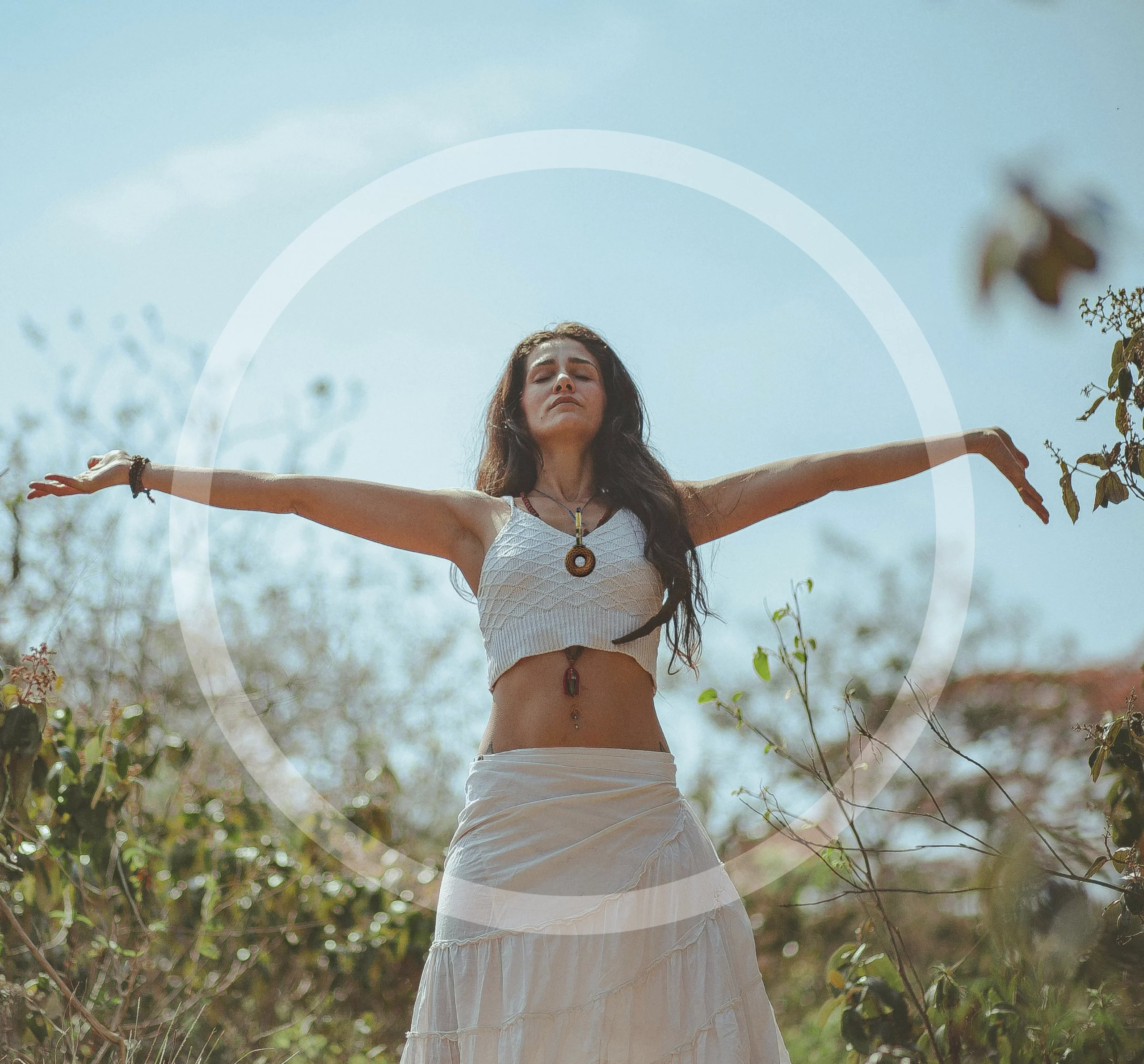 Woman outdoors wearing an OTORUS pendant during a quiet moment